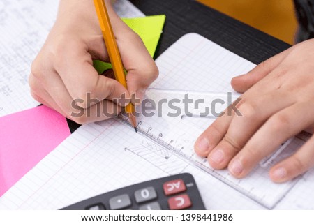Schoolboy Hands with Ruler Drawing on Paper. Mathematics Concept.