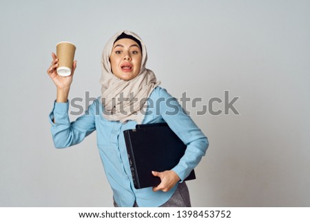 woman with documents holds a glass in hand                               