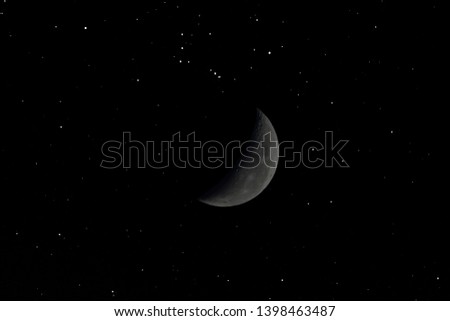 Blurred crescent moon with little stars in the dark night.