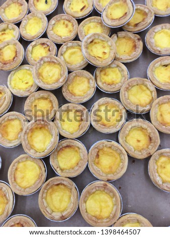 Close up egg tarts dessert for sale in bakery shop at supermarket.Delicious breakfast dessert for coffee break at the morning time.