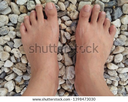 Closeup barefoot on the pebble ground