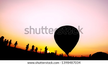 Abstract Balloon festival background. Silhouette people and hot air balloons in the Balloon festival with abstract colorful pink and orange sky.