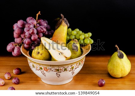 beautiful still life of ripe grapes and pears