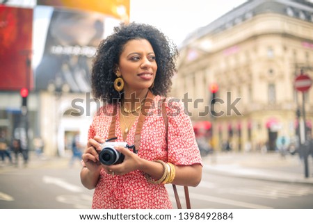 Woman vising a city, making photos