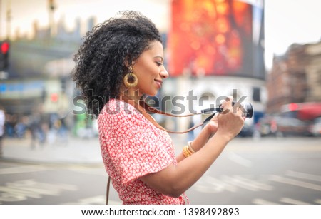 Beautiful woman taking photos with her camera