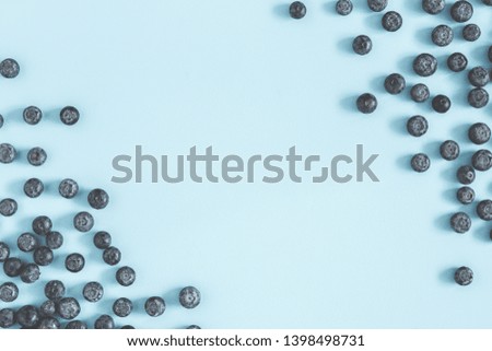 Blueberry on blue background. Flat lay, top view