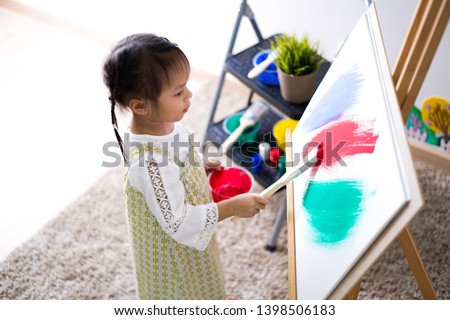 Asian cute little child girl drawing at home. Education concept