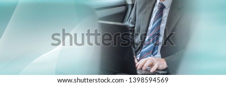 Businessman using his laptop while traveling. panoramic banner