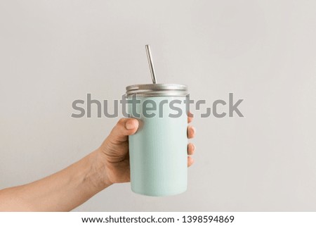 Reusable blue jar with metal straw for summer drinks. Individual use. Save the planet. Zero waste concept. No plastic.