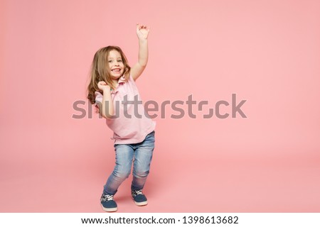 Little cute child kid baby girl 3-4 years old wearing light clothes dancing isolated on pastel pink wall background, children studio portrait. Mother's Day, love family, parenthood childhood concept Royalty-Free Stock Photo #1398613682