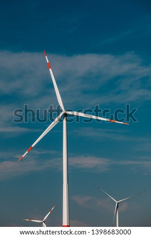 farm with windmills on a background of blue sky