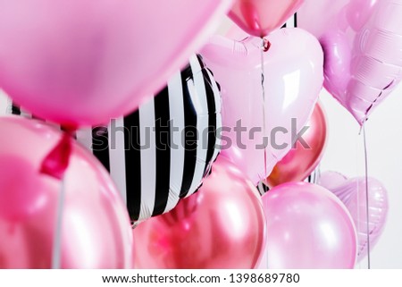 Set of balloons in the form of a heart and round pink and striped on light background with copy space.