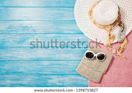 Top view of blue planks marine pier near the beach. Frame composition with summer accessories. Background with copy space and visible wood texture. Border composition