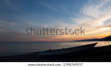 Sea ​​coast sunset and boat