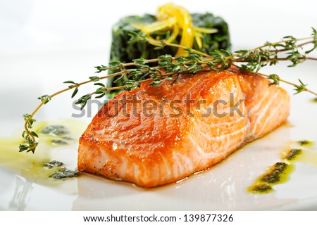 Baked Salmon Steak with Spinach and Lemon Slice Royalty-Free Stock Photo #139877326