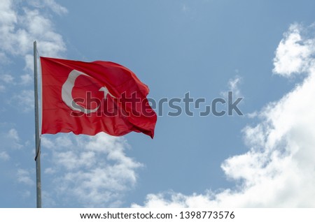 Turkish flag is waving in blue sky