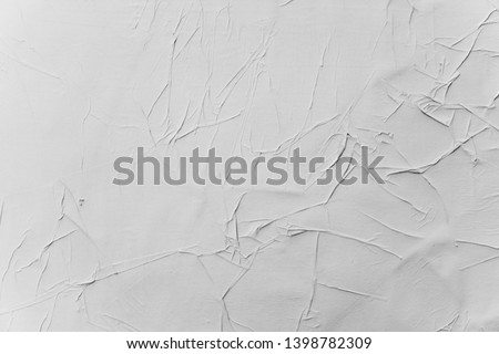 Crumpled creased posters grunge paper textures.
Blank old ripped torn street billboard posters background.