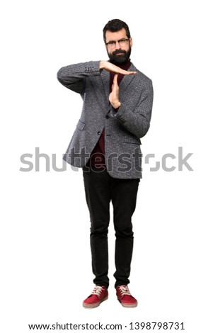 Handsome man with glasses making time out gesture over isolated white background
