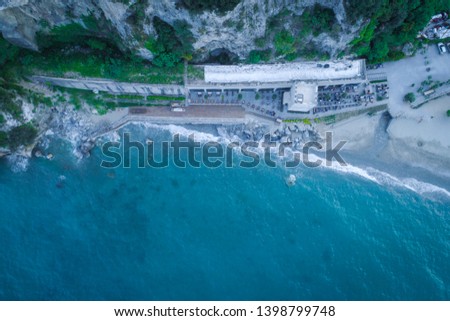 Aerial view of a beach bar on the end of the beach.