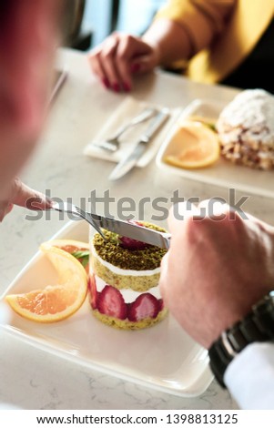 Closeup of man eating cake in a cafe