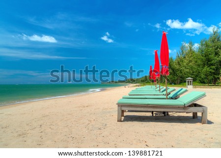 Deck chairs on tropical beach in Thailand