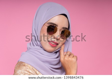 Beautiful female model wearing peplum dress with hijab, a modern lifestyle outfit  for Muslim woman isolated over white background. Eidul fitri fashion and beauty concept.