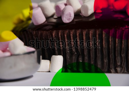chocolate mudcake, with marshmallows and a metal cup with coloured spots on the image to create an effect. This is a commerical product stock photo 