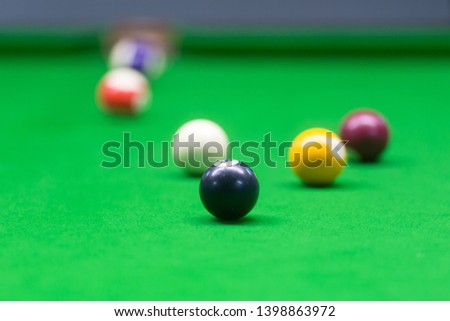 black eight ball on green pool