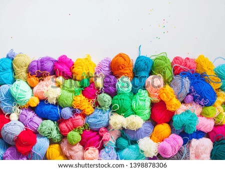Colorful balls of knitting yarn. Color yarn for knitting, knitting needles and crochet hooks.