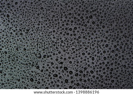 Close up of water drops on gray tone background. Abstract black wet texture with bubbles on plastic PVC surface or grunge. Realistic pure water droplets condensed. Detail of canvas leather texture
