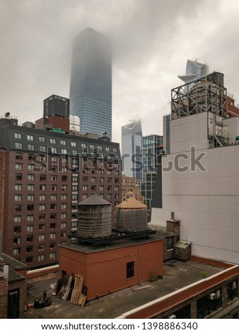 View of the roofs of Midtown Manhattan in New York City on a foggy day.