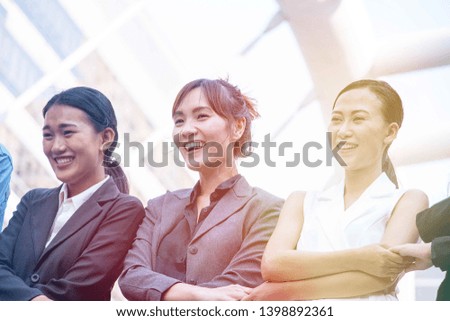 Group of smart women in suit are standing together with smiling face with sign of positive body language.