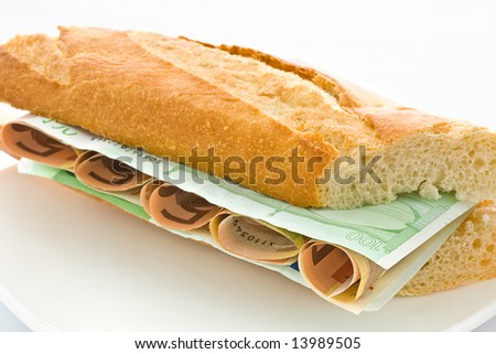 Fresh white loaf with a layer of monetary denominations inside