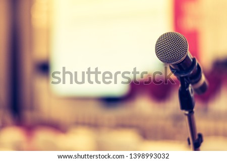 Business seminar, speech presentation, town hall meeting event in lecture hall or conference convention room in corporate or community event for host or public hearing with microphone voice speaker Royalty-Free Stock Photo #1398993032
