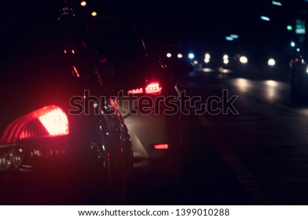 Blurred image of Cars on the road in traffic junction at night there are many car on the road.