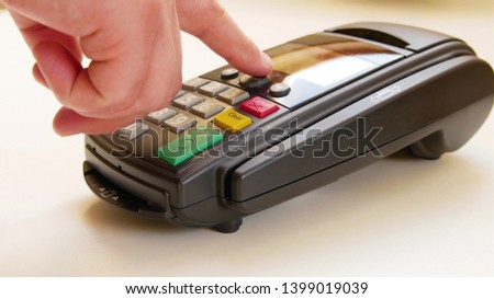 Payment terminal - a finger entering the PIN code
