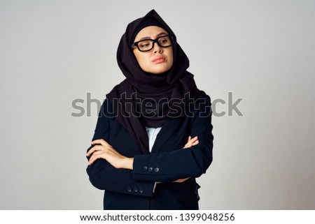   hijab woman in a black veil points serious                             