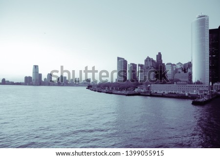 View of the harbor and the skyline of South Manhattan, in New York. Blue black and white image