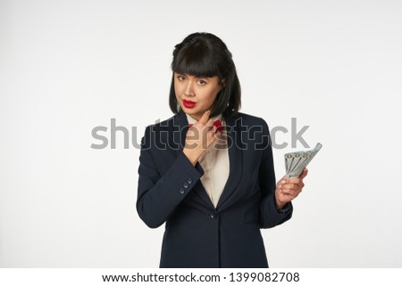 woman in a business suit with money                               