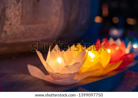 Colored lanterns and garlands at night on Vesak day for celebrating Buddha's birthday in Eastern culture, that made from paper and candle Royalty-Free Stock Photo #1399097750
