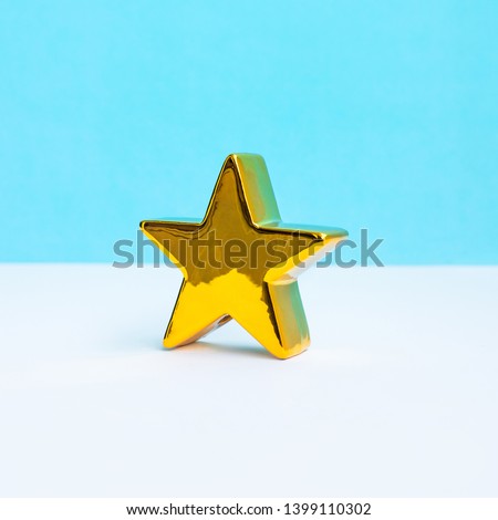 Gold star on pastel color background.Minimal style