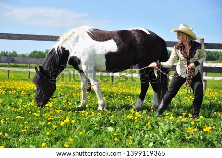 Horse Love, girl in a cowboy hat with a horse in a meadow