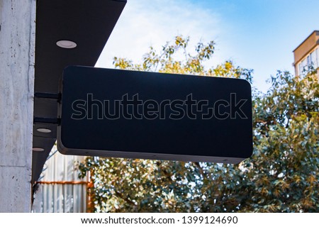 signboard mockup and template empty dark frame for logo or text on exterior street advertising city shop background, modern flat style