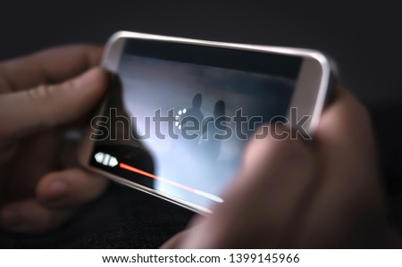 Slow internet, video load and download speed. Watching movie online. Loading icon on screen. Frustrated angry person with poor and bad broadcast connection for entertainment. Man with mobile phone. Royalty-Free Stock Photo #1399145966