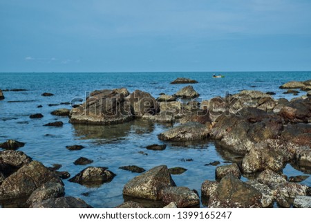 seascape with blue sky and the foreground rock