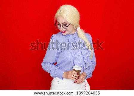 Portrait of attractive pretty lovely nice blonde haired woman in business style clothing, holding a paper-cup coffee, isolated over red background