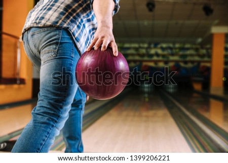Man playing bowling in club