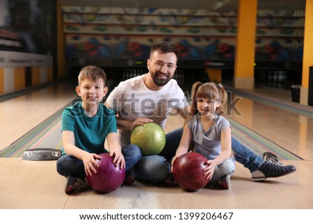 Happy family in bowling club