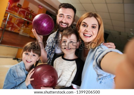 Family taking selfie at bowling club