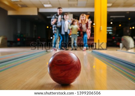 Family playing bowling in club
